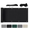 A rolled-up black privacy screen with grommets, along with zip ties and rope, displayed on a white background. Below are swatches of different color options for the screen. Podgląd zdjęcia produktu