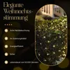 A close-up of a bush decorated with warm white LED lights, with text describing product features on the left. Produktbild-Vorschau