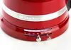 Close-up of the base of a red KitchenAid kettle, showing the speed dial and indicator lights. Produktbild-Vorschau