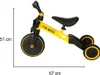 A yellow and black children's trike with measurement indicators. Podgląd zdjęcia produktu