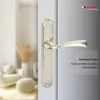 A close-up of a door handle on a door, with a blurred background of a room interior. Produktbild-Vorschau