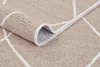A close-up view of a rolled-up beige rug with a white geometric pattern and a white border. Náhľad obrázku produktu