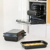 Kitchen scene with cookware on a countertop and an open oven. Podgląd zdjęcia produktu