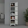 A tall, gray metal locker unit with five open doors, displaying various items inside, set against a plain gray wall. Voir les images du produit