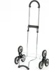 A shopping trolley with three wheels on each side, designed for climbing stairs, is shown against a white background. Podgląd zdjęcia produktu