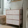 A bathroom scene with a toilet and a storage cabinet. Podgląd zdjęcia produktu