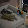 A bedroom scene at night with a daybed, pillows, and a tablet charging. Podgląd zdjęcia produktu