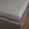 A close-up view of a fitted sheet on a mattress base. Produktbild-Vorschau