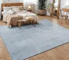 A bedroom scene with a bed, rug, and furniture. Anteprima dell’immagine prodotto