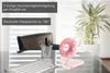 Der Unold HANDVENTILATOR BREEZY FOLD, ein kleiner Tischventilator, steht auf einem Glastisch  Produktbild-Vorschau