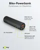 A black cylindrical power bank with labels pointing out its features. Produktbild-Vorschau