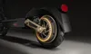 Close-up view of the rear wheel and suspension of an electric scooter. Produktbild-Vorschau