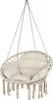 A hanging chair with cushions and fringe, isolated on a white background. Voir les images du produit