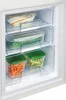 Close-up view of the freezer drawers of a refrigerator, filled with various food items in clear containers. Produktbild-Vorschau