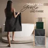 A woman is holding a large dark gray towel in a bathroom setting with a bathtub and a towel rack displaying multiple towels. Produktbild-Vorschau