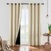 A room interior with beige curtains covering a window, a chair with a blanket, and a small table with a plant and a cup. Produktbild-Vorschau