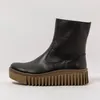 A black leather boot with a thick brown sole is shown against a white background. Produktbild-Vorschau