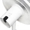 Close-up of a white electric fan's control panel and front grill. Voir les images du produit
