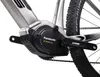 A close-up view of the electric motor and crankset of a silver e-bike. Produktbild-Vorschau