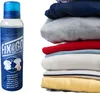 A spray bottle and a stack of folded clothes. Produktbild-Vorschau