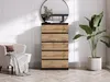 A chest of drawers is placed in a room with a chair and a plant. Voir les images du produit