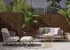 An outdoor patio setting with modern furniture and plants. Produktbild-Vorschau