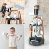 A collage of images showing a child playing with a toy cleaning set and close-ups of the cleaning set itself. Produktbild-Vorschau