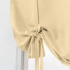 A close-up view of a beige tie-up curtain. Voir les images du produit