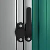 A close-up view of a black latch mechanism on a silver and green surface, likely a door or window frame. Náhľad obrázku produktu