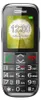 A close-up studio shot of a black Maxcom MM720 senior mobile phone against a blurred green background, displaying the time and date on its screen. Náhľad obrázku produktu