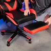 A person's hands are shown adjusting the footrest of a gaming chair. Náhled obrázku produktu