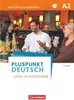 Three people sitting at a table in a cafe or restaurant, appearing to be in conversation. Produktbild-Vorschau