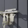 A close-up of a metal door bolt lock attached to a gray door. Náhľad obrázku produktu