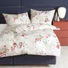 A bed with a duvet and pillows featuring a winter-themed snowman print. Produktbild-Vorschau