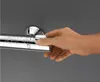 A hand is shown adjusting a chrome shower thermostat with water droplets on it. Náhľad obrázku produktu
