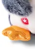 A close-up of a plush penguin toy's foot and chest. Produktbild-Vorschau