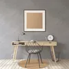 A desk with a chair, lamp, clock, and trash can in a modern room. Produktbild-Vorschau