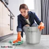 A woman is cleaning the floor in a kitchen with a bucket and cloth. Náhled obrázku produktu