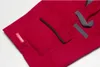 A close-up view of a red garment with gray accents and pockets. Produktbild-Vorschau