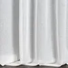 A close-up view of white curtains with a textured fabric. Produktbild-Vorschau