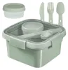 A square lunch box with a small container inside and cutlery. The lunch box is light green and the cutlery and inner container are gray. Podgląd zdjęcia produktu