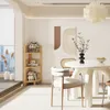 A bright and airy dining room with a round white table and chairs. Produktbild-Vorschau