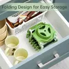 A kitchen drawer containing kitchen utensils, mugs, and a green vegetable slicer. Produktbild-Vorschau