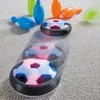 A hover soccer ball toy is shown on a carpeted floor, with several colorful bowling pins in the background. Podgląd zdjęcia produktu