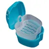 A blue and clear plastic denture bath with its lid open, shown against a white background. Produktbild-Vorschau