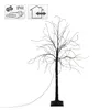 A decorative LED tree with bare branches and small lights, standing on a square base with a power cord extending from it. Two informational icons are in the top left corner. Náhled obrázku produktu