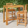 A wooden bar table and stools set on a patio with greenery in the background. Produktbild-Vorschau