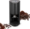 A black automatic espresso tamper with a digital display, shown with coffee beans and ground coffee. Produktbild-Vorschau
