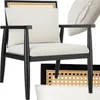 A modern armchair with a cane back and upholstered seat and cushion, shown with a close-up of the cane pattern and another cushion. Náhled obrázku produktu