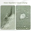 Close-up of a green fabric with water droplets, demonstrating water repellency and quick-drying properties. Produktbild-Vorschau